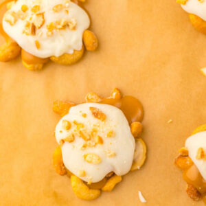 White chocolate and chopped cashews on top of the caramel and cashew bases, ready to cool and set up.