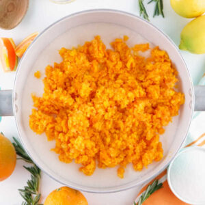 Finely minced pieces of orange in a pot, ready to be made into marmalade.