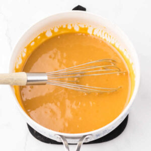 Pan of homemade sweetened condensed milk caramel for cashew clusters.