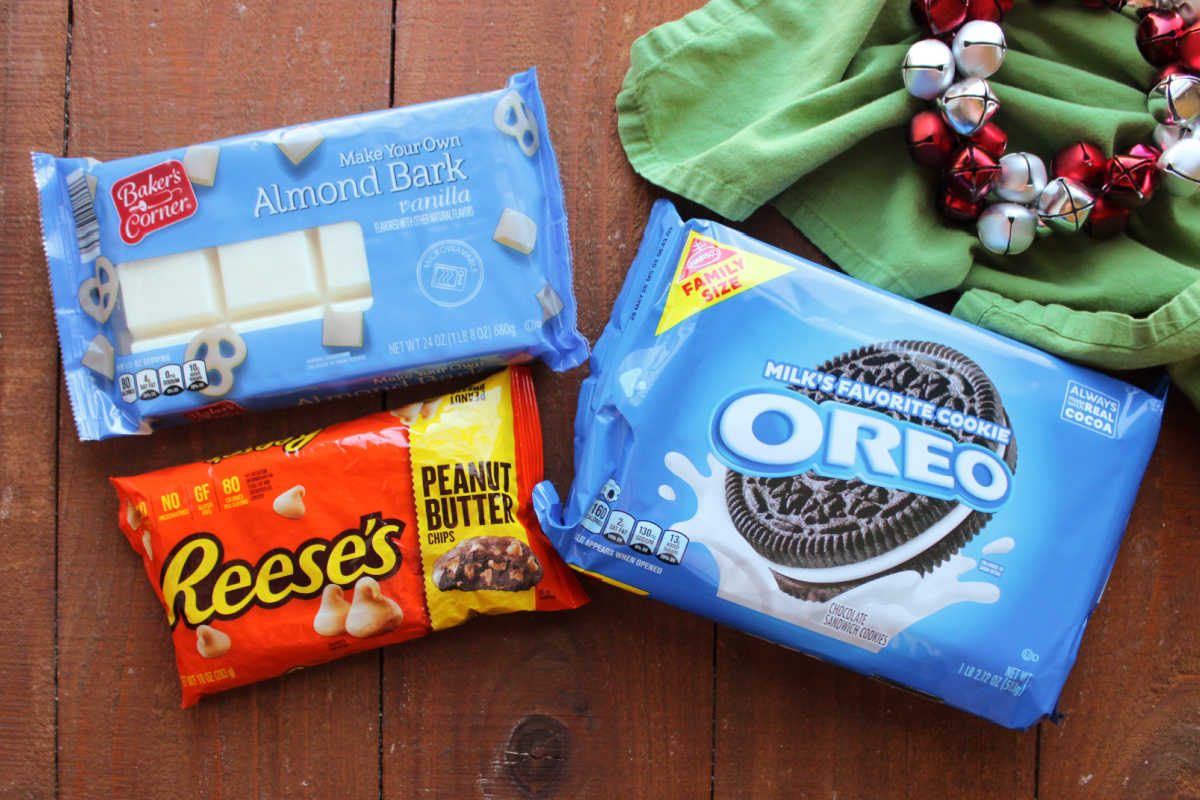 Ingredients including almond bark, peanut butter chips, and oreos ready to be made into peanut butter dipped Oreos. 