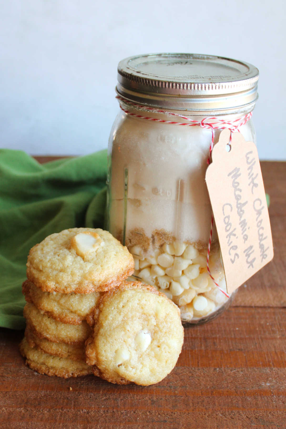 Buttery  homemade white chocolate macadamia nut cookies next to a jar of homemade mix. 