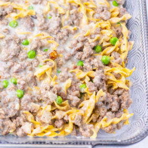 Amish Country Casserole 13 Baking dish with creamy mixture of egg noodles, peas, and ground beef ready to get covered with foil and go in the oven.