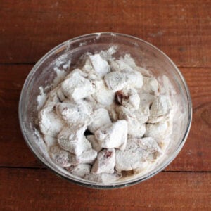 Chunks of venison roast coated in seasoned flour, ready to be made into stew.