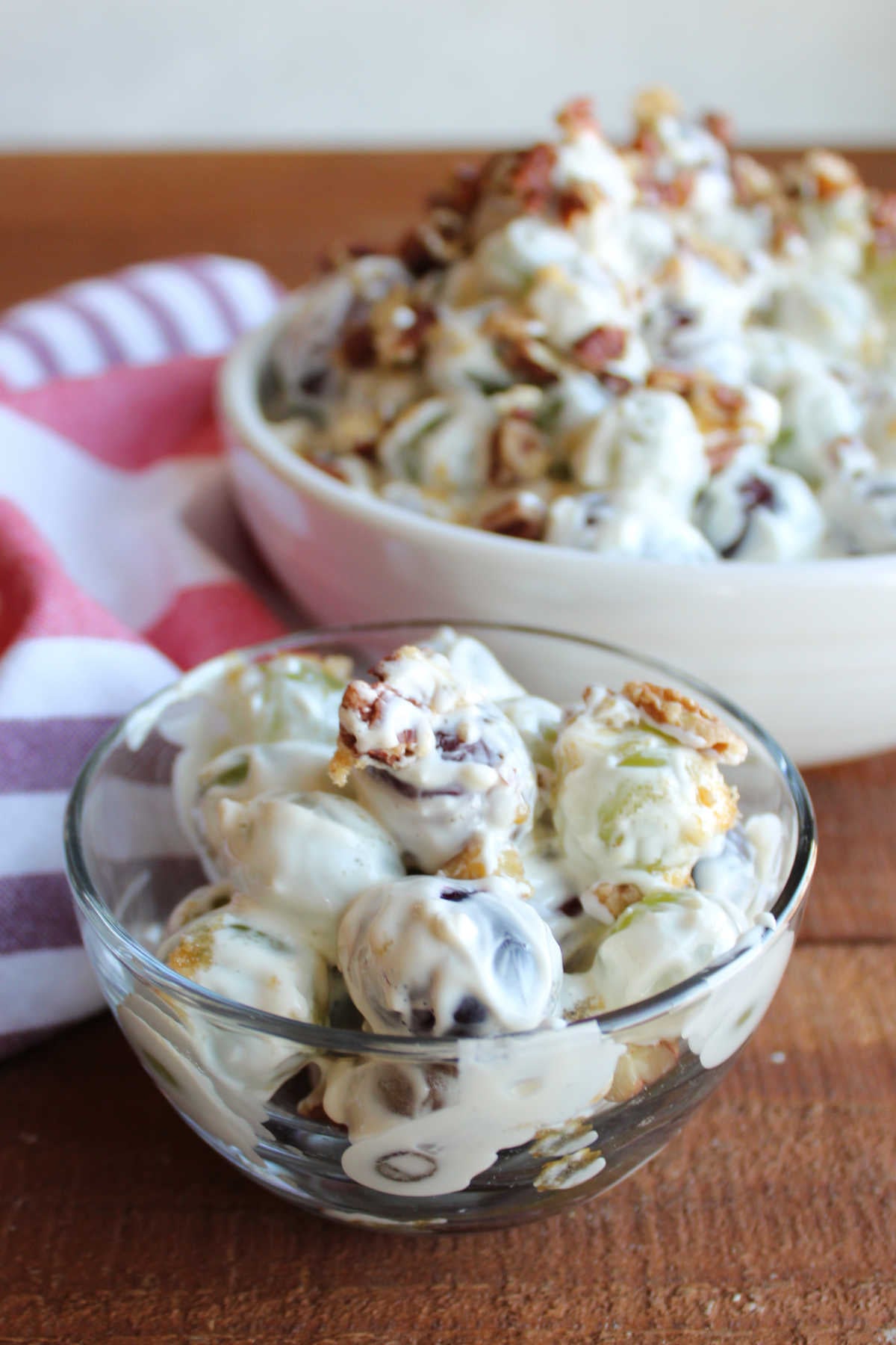 Small glass bowl of creamy grape salad, ready to eat. 