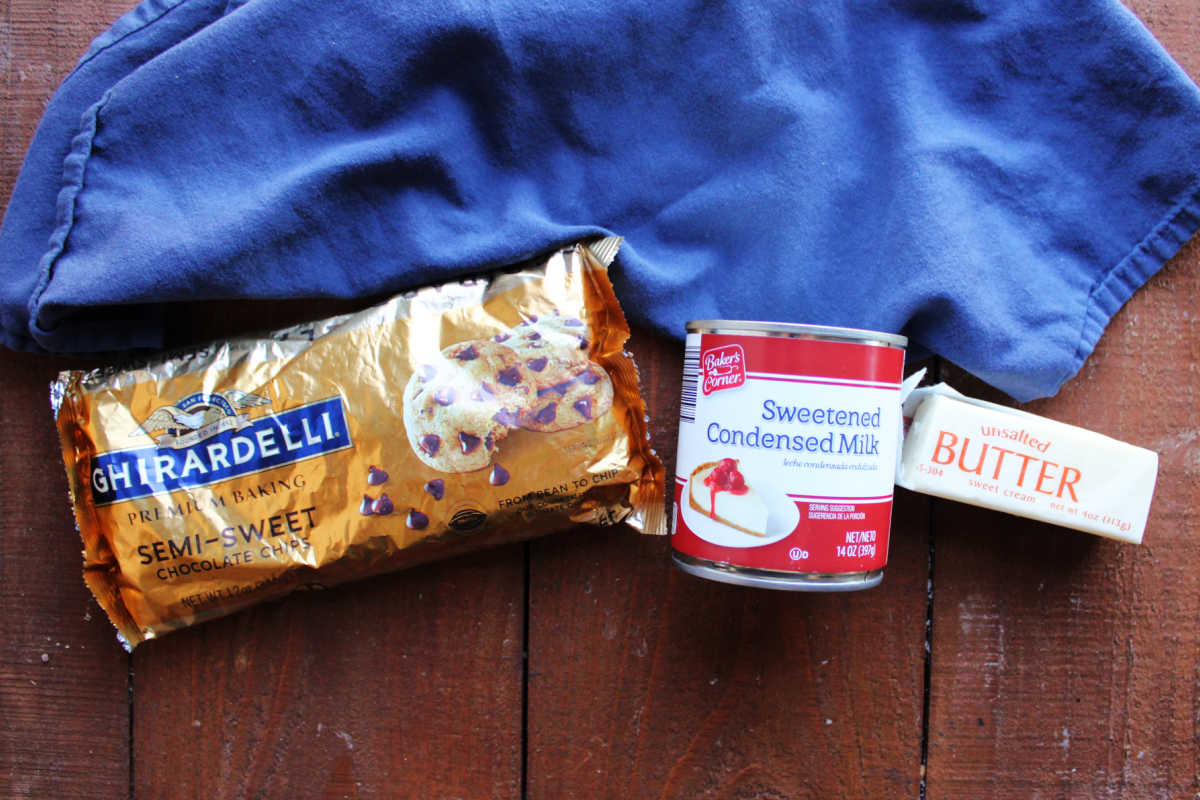 Ingredients including chocolate chips, sweetened condensed milk, and butter ready to be made into homemade hot fudge sauce. 