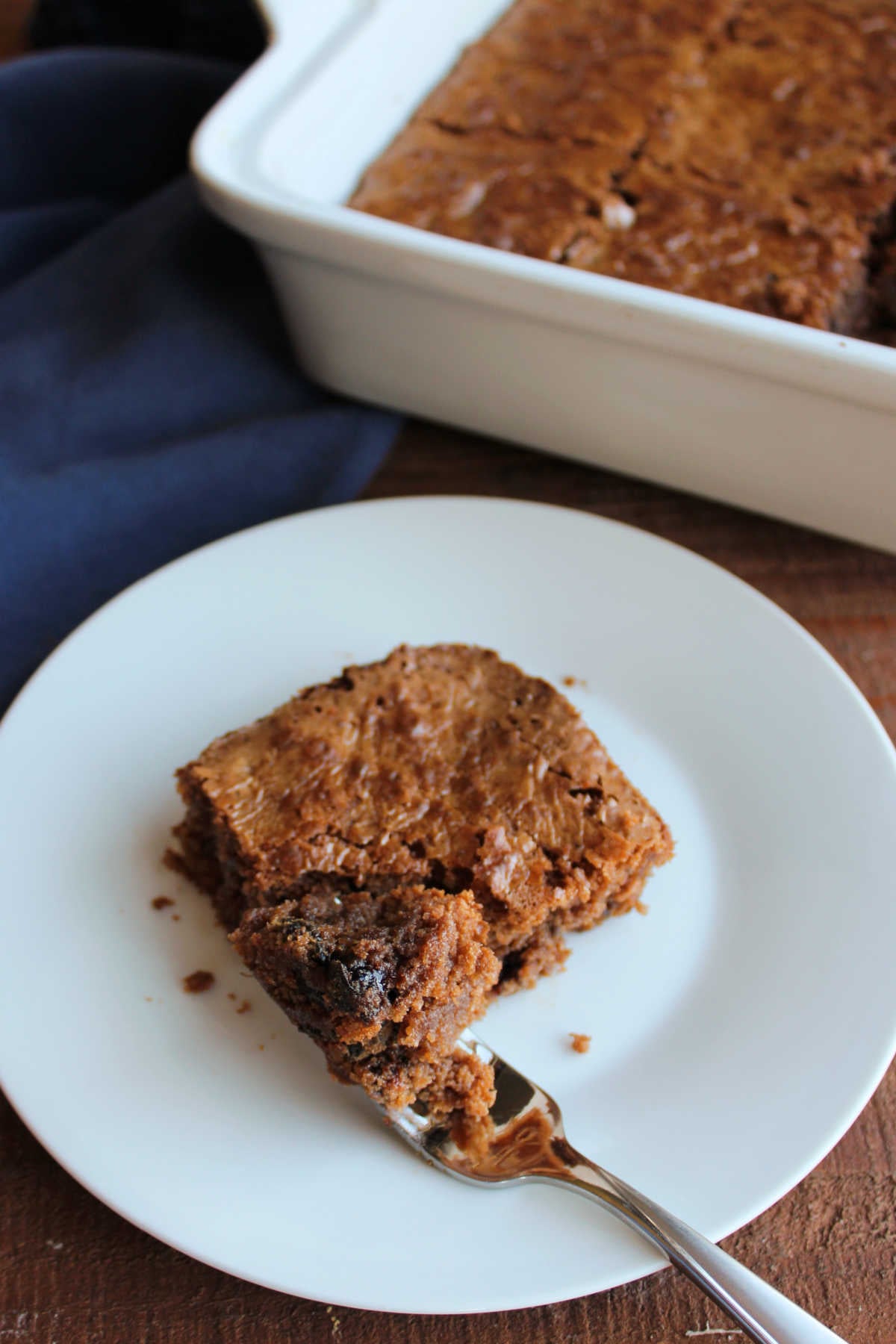 Bite of prune brownie on fork, ready to eat. 