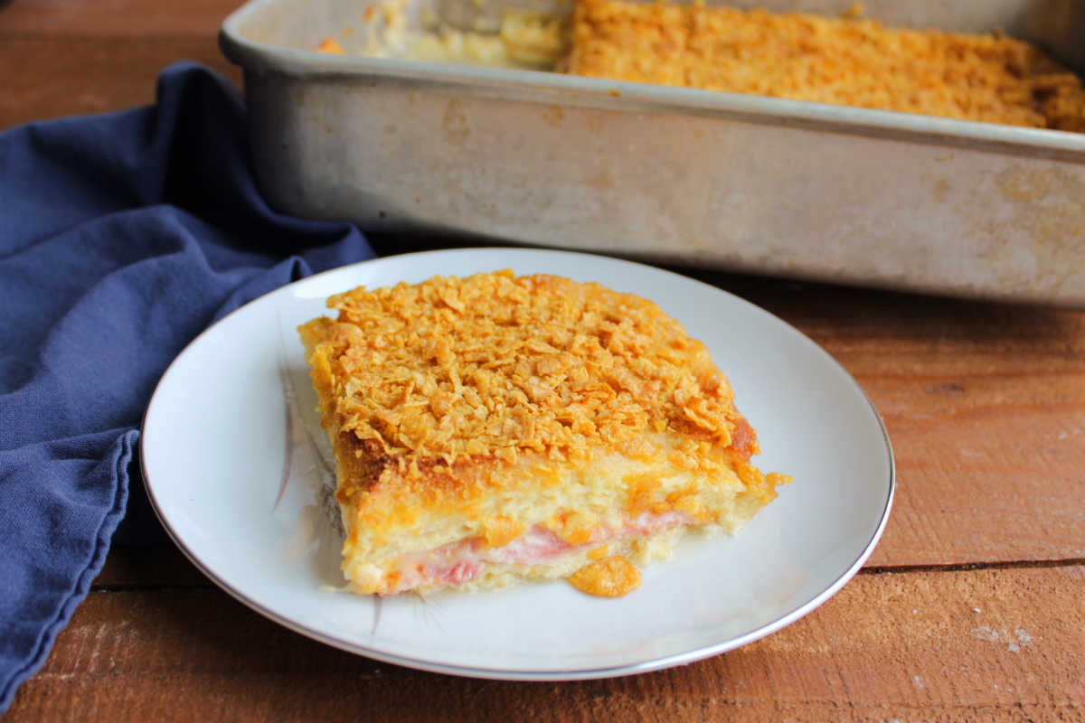 Hot Ham Sandwich Breakfast Bake 5 Hot ham sandwich breakfast baked with egg soaked bread filled with ham and melted cheese topped with cornflakes, ready to eat.