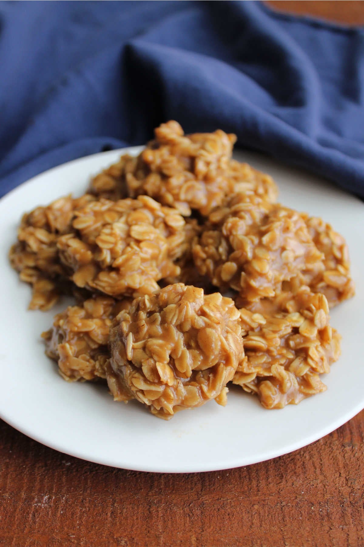 Close up of a plate of maple no bake cookies showing the maple mixture holding together the oats to form cookie shapes. 