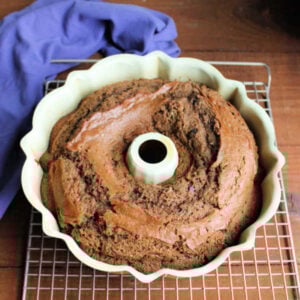 Baked sourdough mocha bread in pan cooling on wire rack.