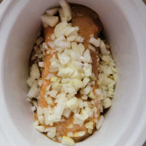 Diced onion and chicken broth added to crockpot with pork loin and honey mustard sauce.