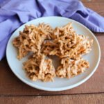 Plate of butterscotch haystacks with crunchy chow mein noodles coated in peanut butter and butterscotch mixture.
