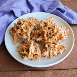 Plate of butterscotch haystacks with crunchy chow mein noodles coated in peanut butter and butterscotch mixture.