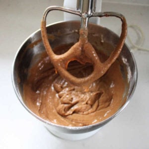 Mixer with smooth mocha sourdough batter inside after coffee, starter, and flour have been incorporated.