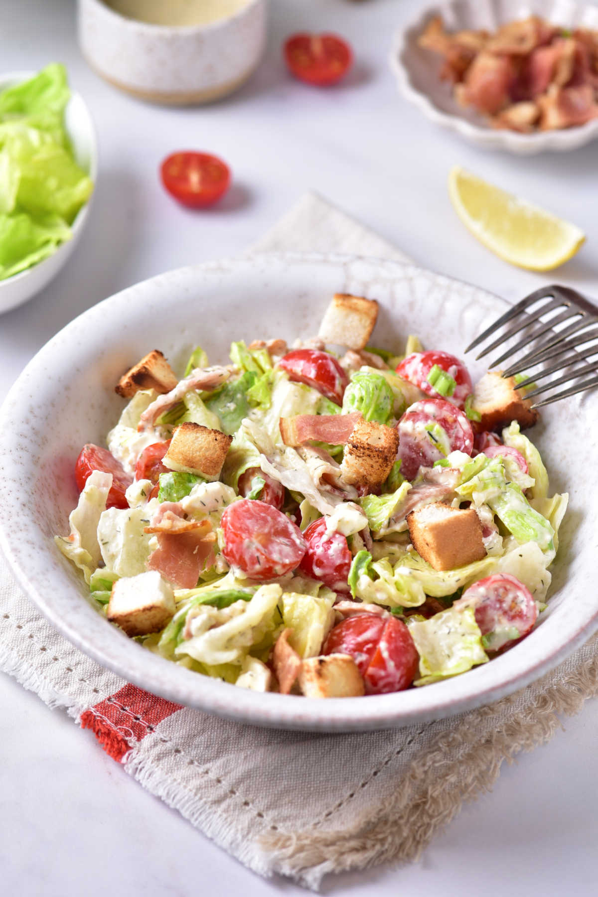 Bowl filled with blt salad, ready to eat. 