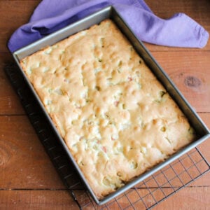 Rhubarb Snack Cake 15 Pan of lightly browned rhubarb snack cake cooling on wire cooling rack.