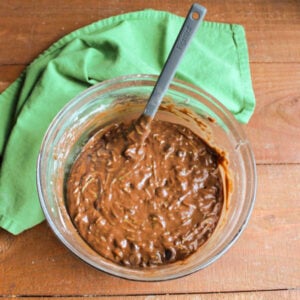 Mixing bowl of thick chocolate zucchini batter ready to go into a loaf pan.