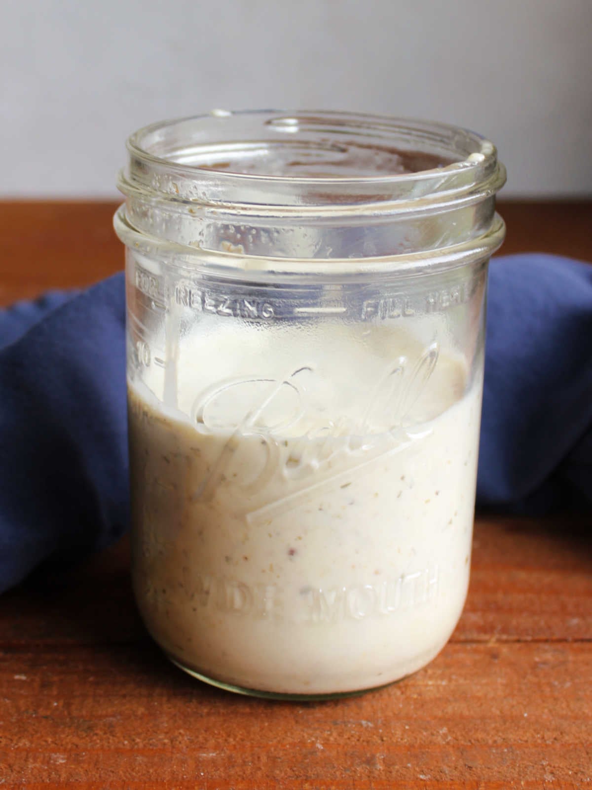 Grinder Pasta Salad 7 Jar of creamy pasta salad dressing made from mayo, vinegar, and seasonings, ready to be used.