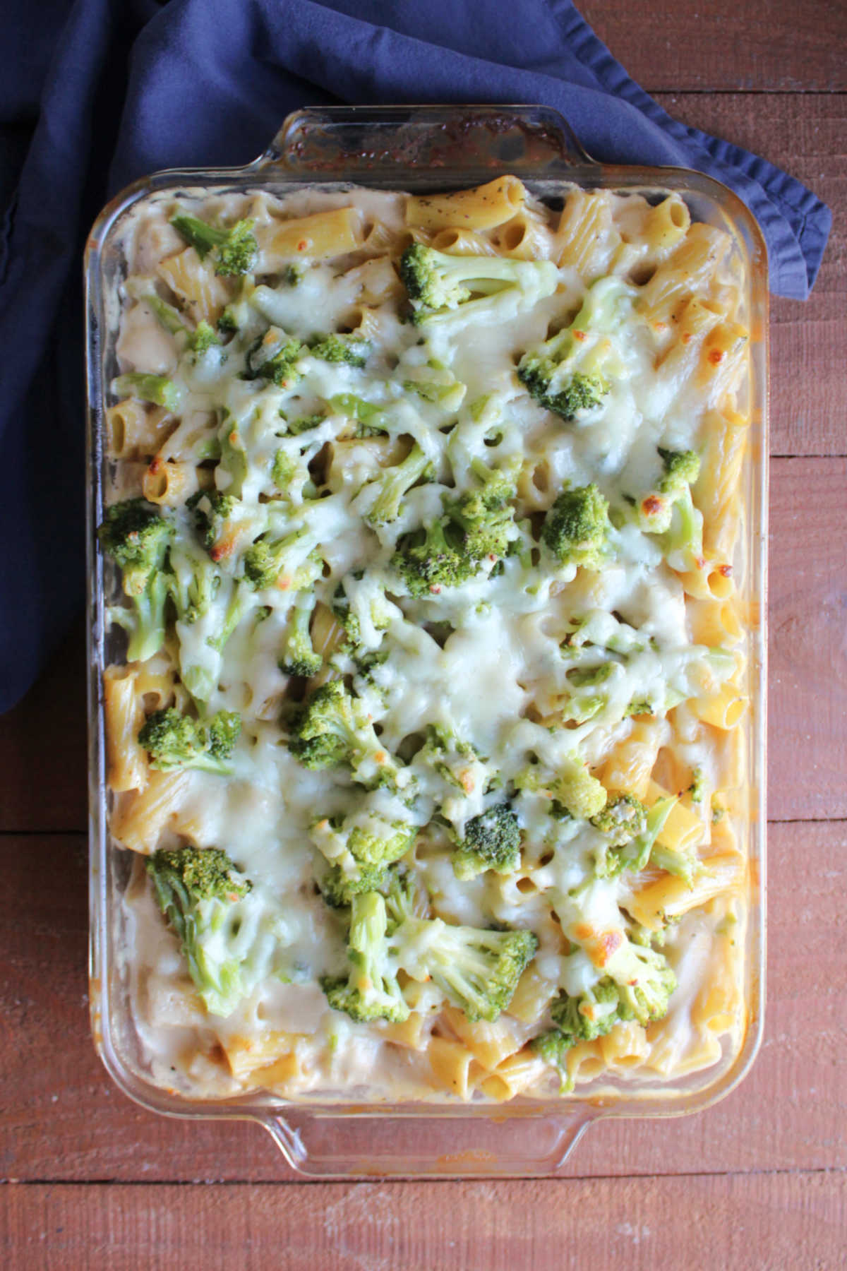 No Boil Chicken Alfredo Bake 6 Glass baking dish filled with dump and bake chicken alfredo with pasta, chicken and broccoli baked in a creamy alfredo sauce topped with melted mozzarella cheese.
