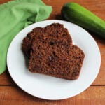 Plate with two slices of double chocolate zucchini bread on it, ready to eat.