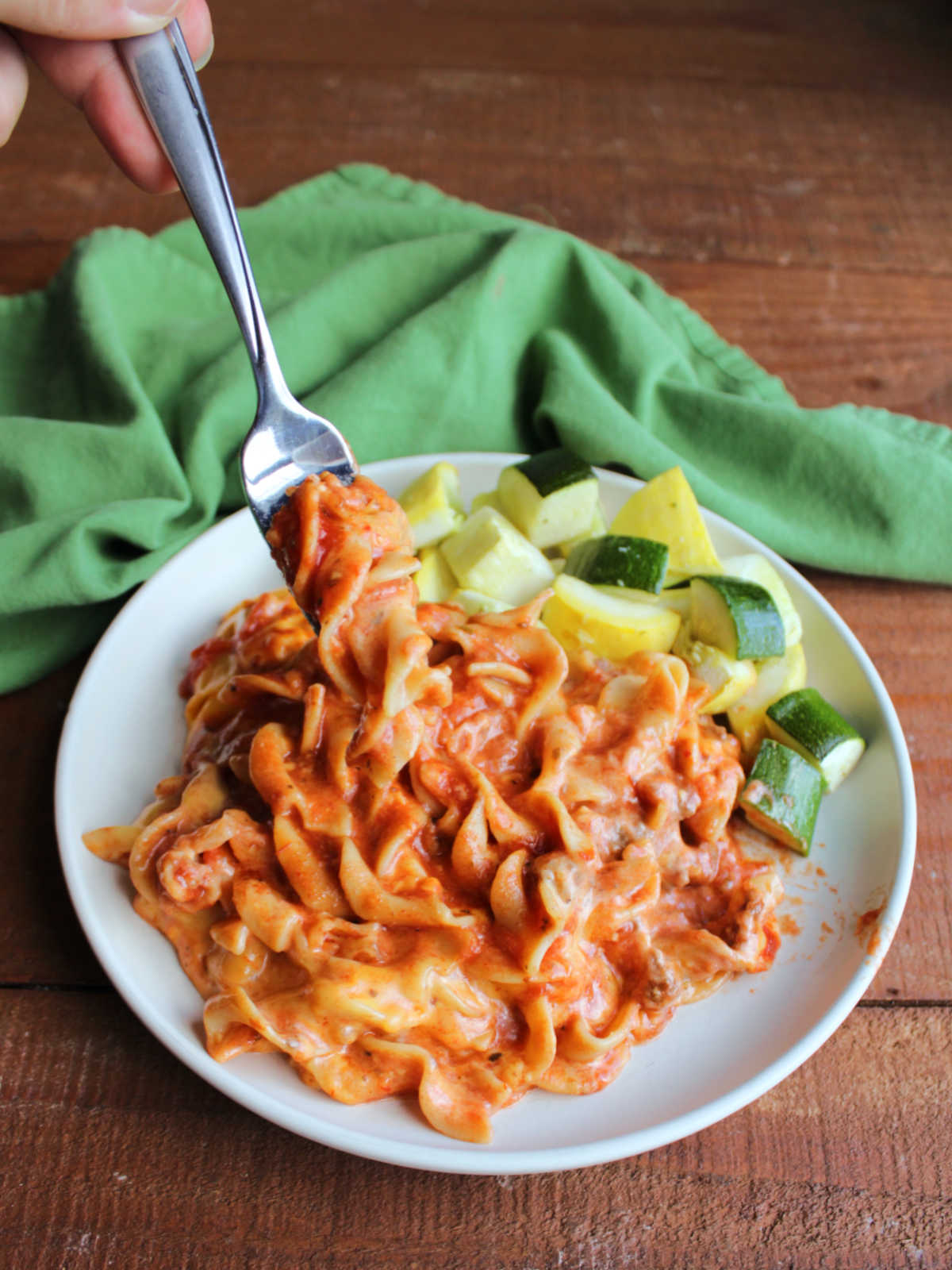 Mom's Lazy Lasagna With Velveeta 7 Bite of saucy lazy lasagna made with meat sauce, egg noodles, and melted cheese on fork, ready to eat.