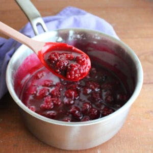 Blackberry Pie Bars 11 Spoon with a scoop of thickened blackberry filling after it has been cooked down.