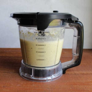 Blender with wet ingredient mixture of cucumbers, eggs, oil, and vanilla.