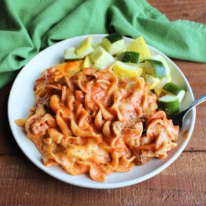 Mom's Lazy Lasagna With Velveeta 9 Plate filled with saucy lazy lasagna with meat sauce and melted Velveeta cheese served with roasted zucchini and summer squash.