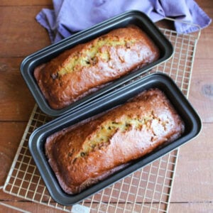 Grandma's Date Nut Bread 17 Two loaf pans with dark golden loaves of date nut bread inside.