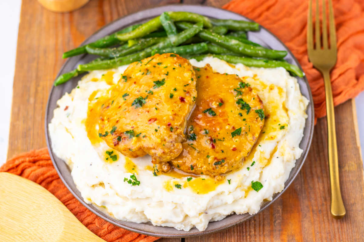 Pork chops baked in a maple dijon sauce served over mashed potatoes with a side of roasted green beans. 