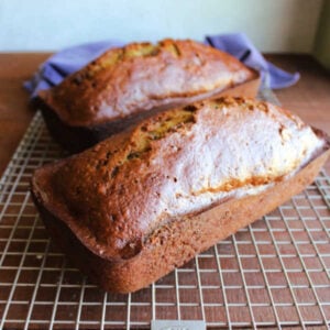 Grandma's Date Nut Bread 18 Two date nut loaves cooling on wire rack showing deep ebony crust.