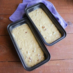 Grandma's Date Nut Bread 16 Loaf pans filled with date nut quick bread batter, ready to go in the oven.