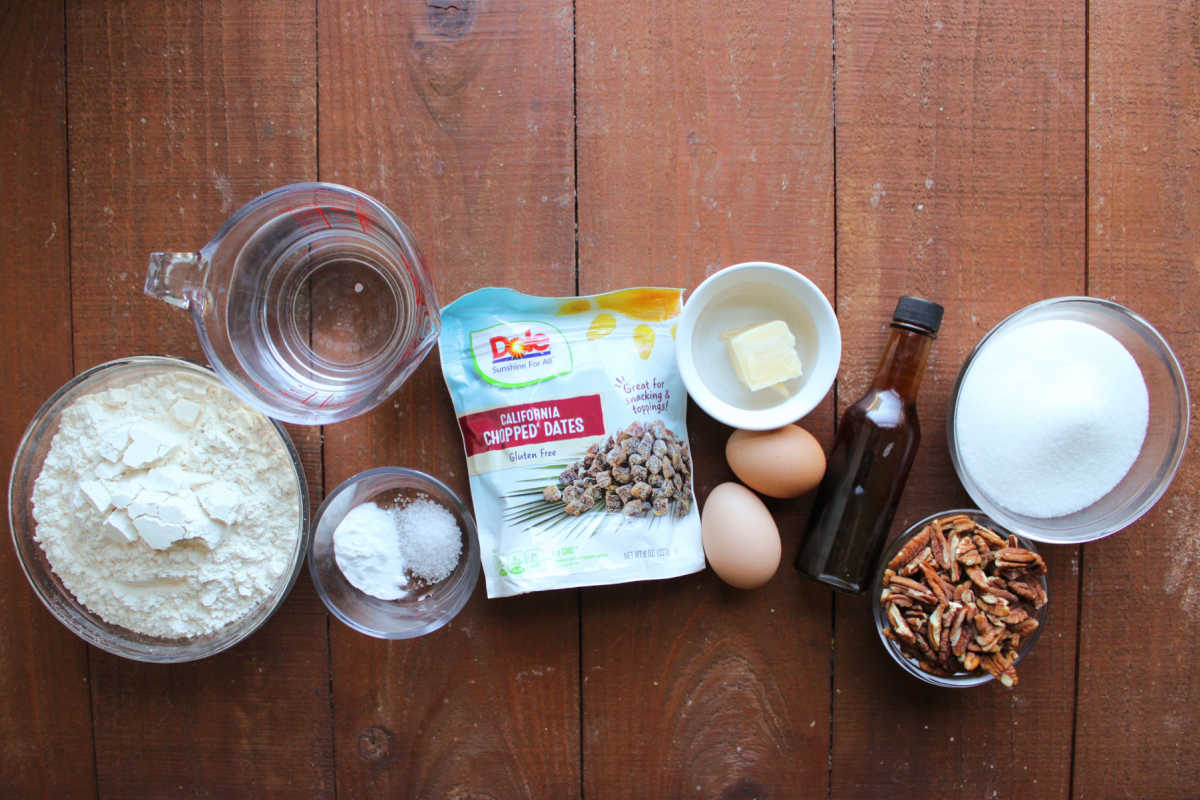 Grandma's Date Nut Bread 6 Ingredients including flour, water, baking soda, salt, chopped dates, butter, eggs, vanilla, nuts, and sugar ready to be made into date quick bread.