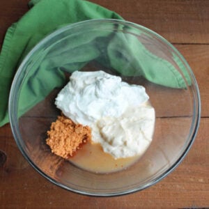 Mixing bowl with mayonnaise, Greek yogurt, taco seasoning and lime juice inside.