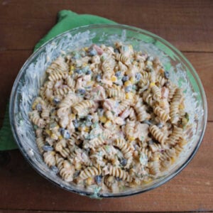 Mixing bowl of southwestern chicken pasta salad after everything has been added and mixed, ready to be chilled.