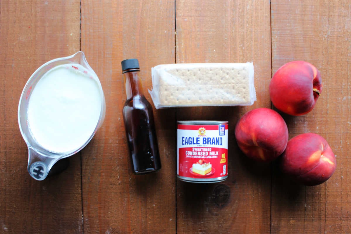 Peaches and Cream Icebox Cake 6 Ingredients including heavy cream, vanilla, graham crackers, sweetened condensed milk, and peaches ready to be made into a peach refrigerator cake.