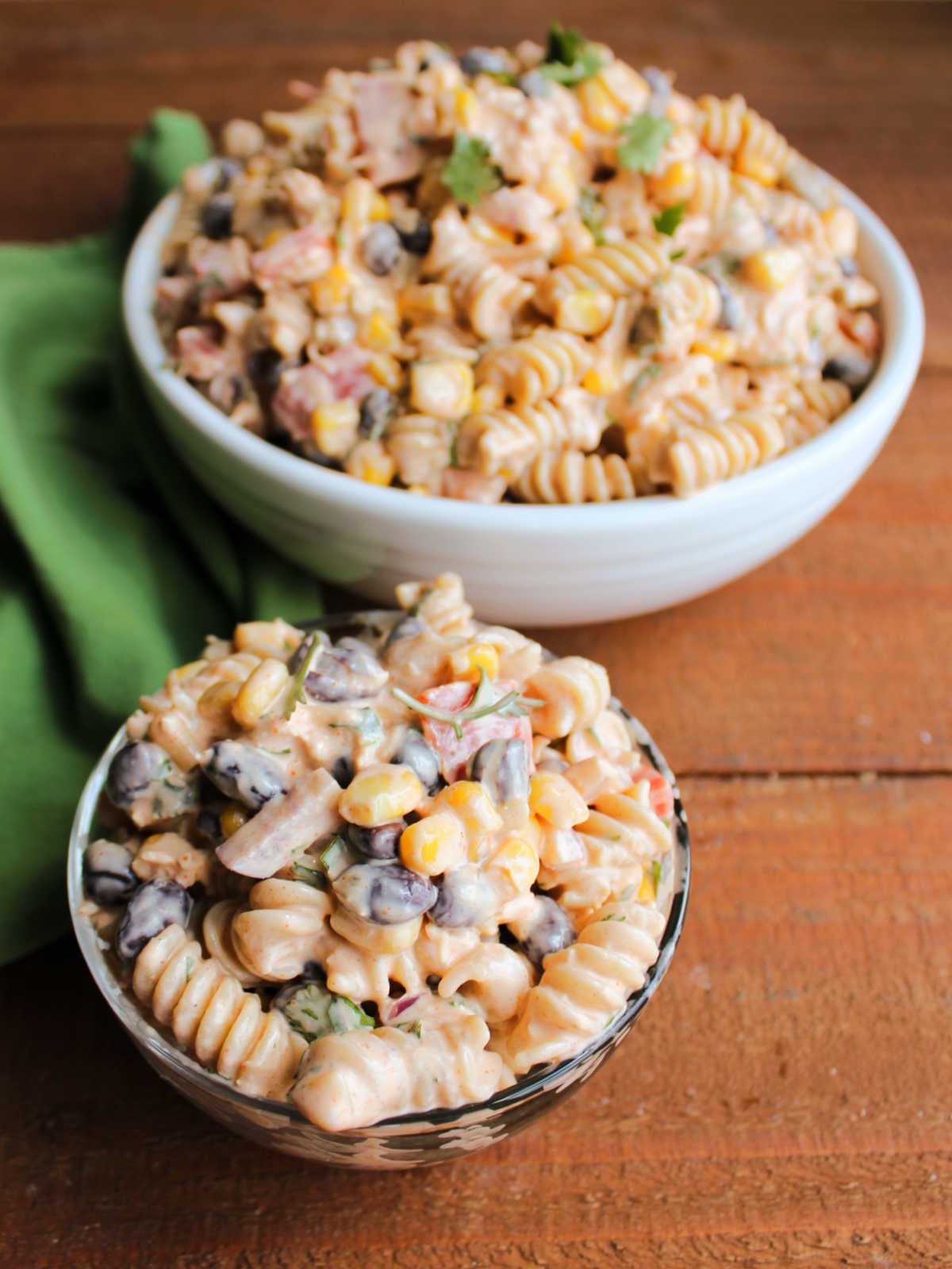 Small bowl of creamy chicken pasta salad with tex-mex inspired dressing, veggies, and cilantro, ready to eat. 