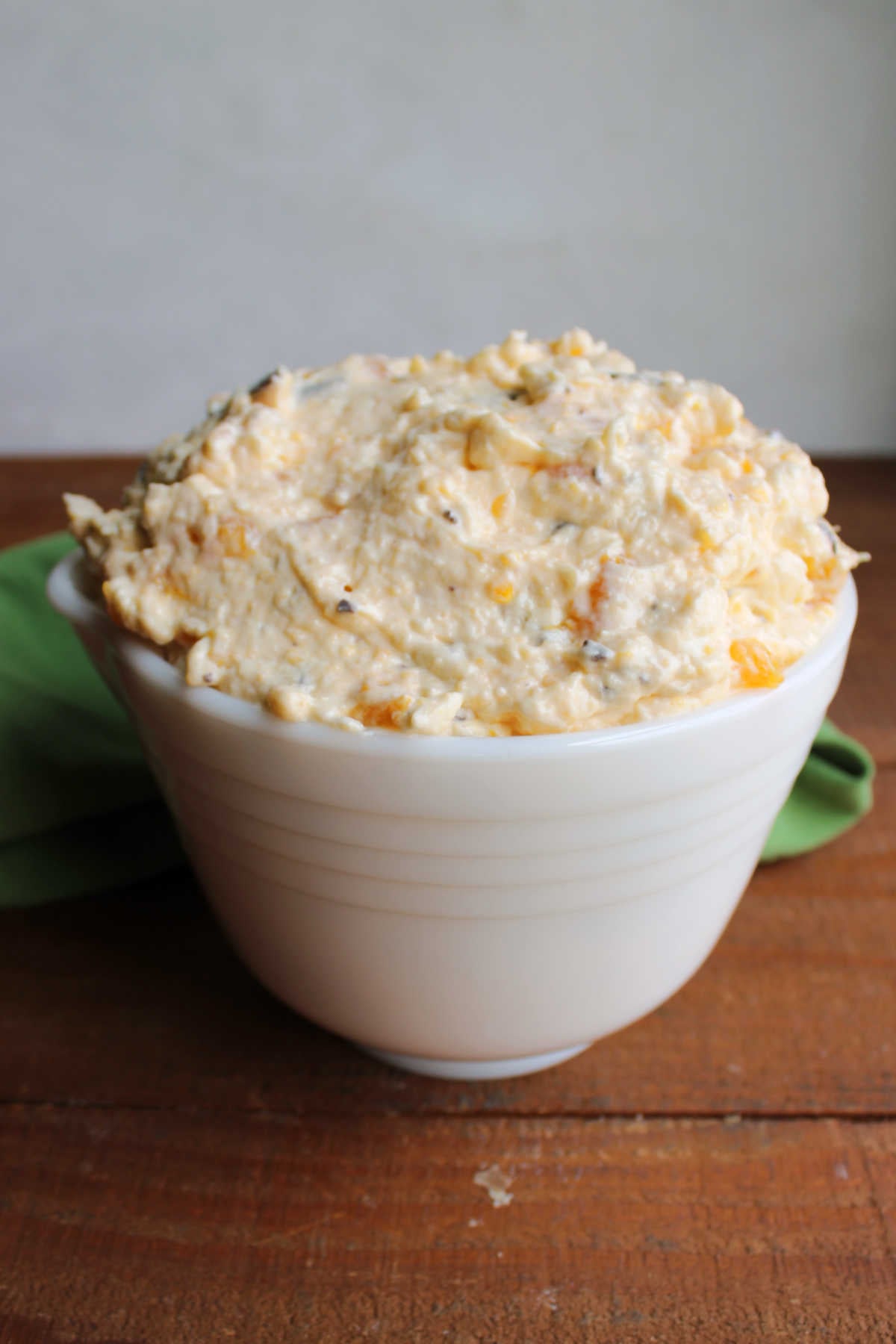 Vintage bowl filled with creamy cookie salad with bits of orange, pineapple, and cookies in a creamy dressing. 