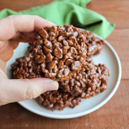 Homemade Star Crunch 1 Hand holding a homemade star crunch cookie with chocolate, caramel, and rice krispies.