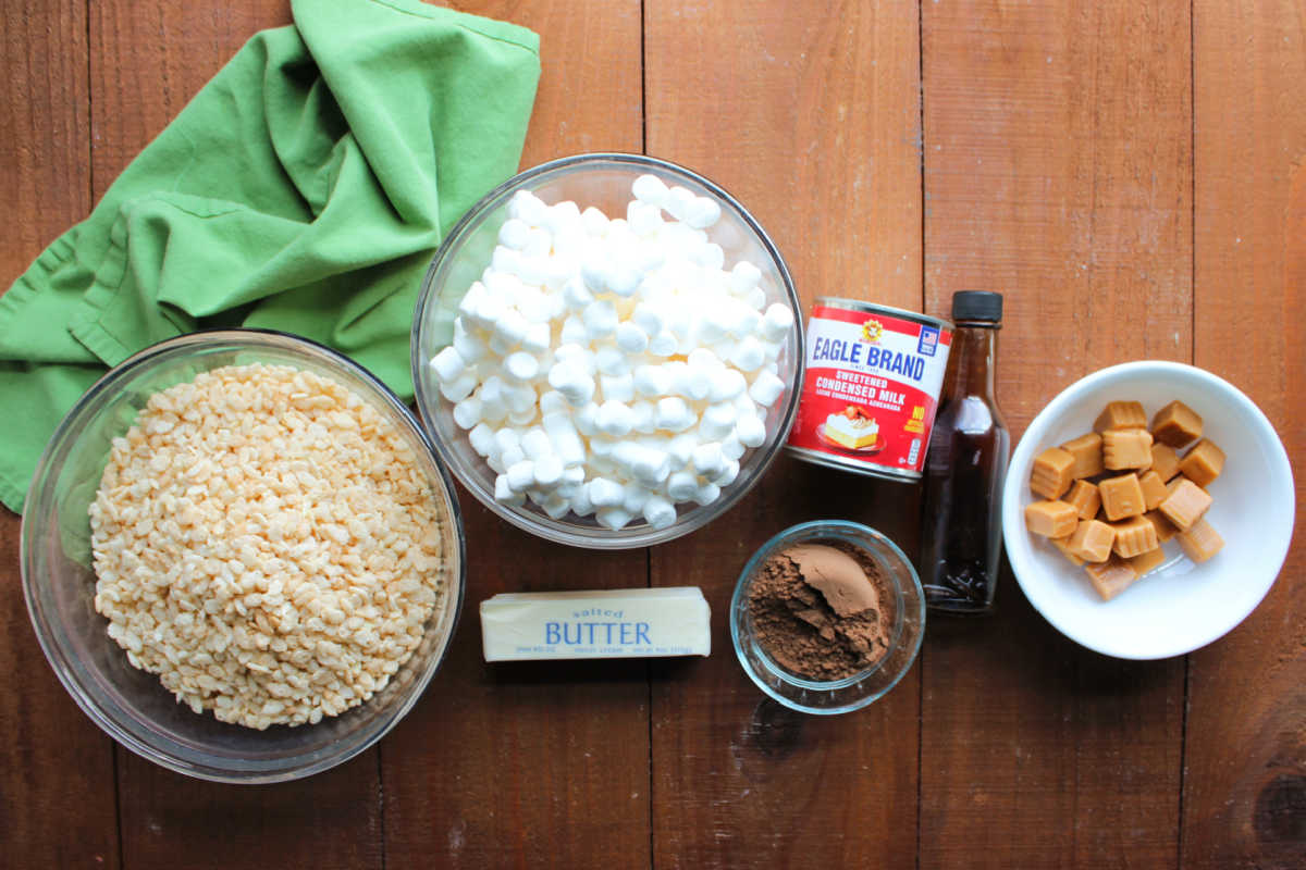 Homemade Star Crunch 6 Ingredients including rice krispies cereal, marshmallows, butter, cocoa powder, sweetened condensed milk, vanilla, and caramel ready to be made into homemade star crunch cookies.