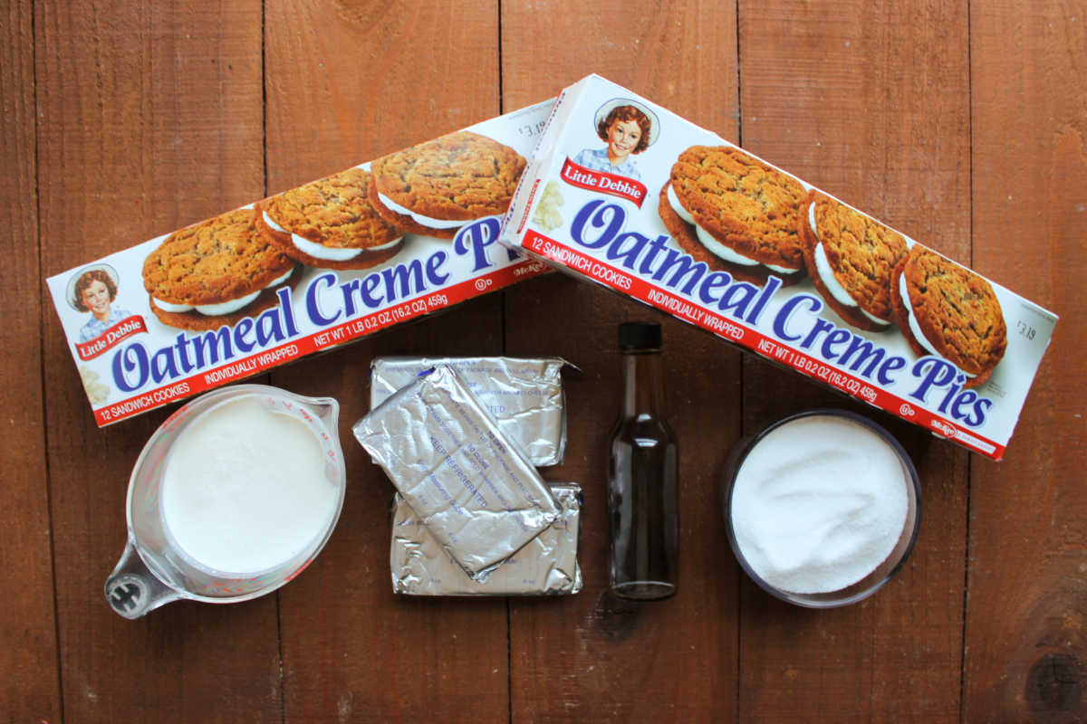 Ingredients including boxes of Little Debbie oatmeal creme pies, heavy cream, cream cheese, vanilla extract, and sugar ready to be made into a no bake cheesecake. 