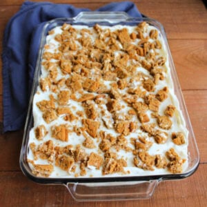 Pan of no bake cheesecake with bits of oatmeal creme pie on top, ready to chill.