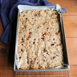 Pan of puffed up baked trail mix bars showing a slight golden color around the edges.