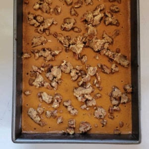 Grandma's Pumpkin Pie Bars 16 Brown sugar, butter, and pecan mixture sprinkled over the pumpkin pie bars, ready to go back in the oven.