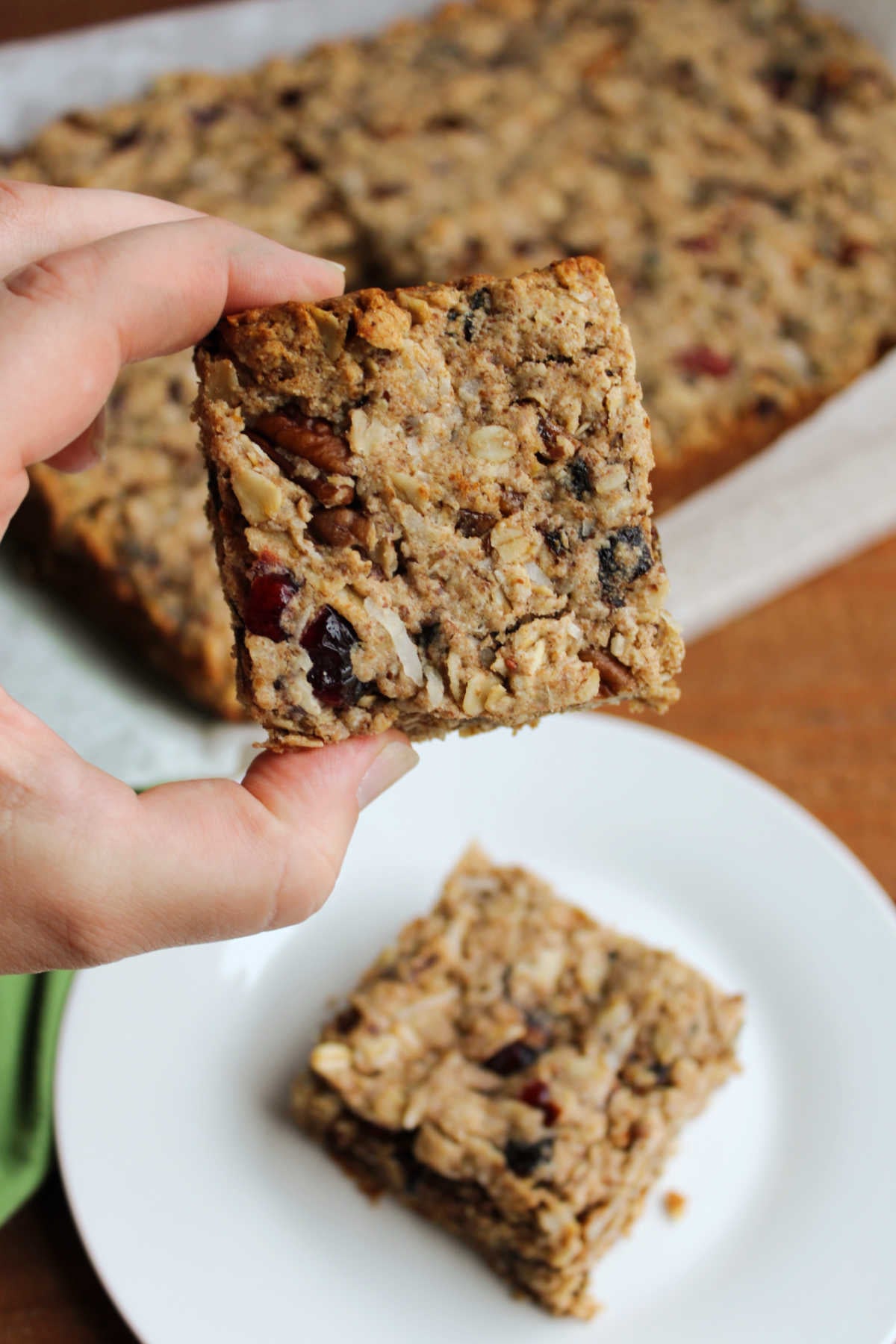 Hand holding a trail mix bar, ready to eat. 