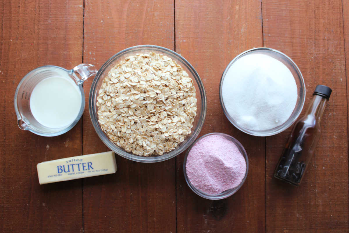 Ingredients including milk, butter, oats, strawberry milk powder, sugar and vanilla ready to be made into no bake cookies. 