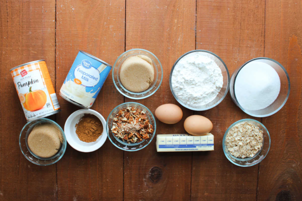 Grandma's Pumpkin Pie Bars 6 Ingredients including pumpkin puree, evaporated milk, brown sugar, sugar, flour, eggs, butter, pecans, oats, and pumpkin pie spice, ready to be made into grandma's pumpkin pie squares.